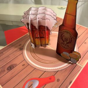 Pop up 3D pint of beer card and a slice of lime - perfect card for Father's Day Please allow 2-3 days for postage. ABOUT YOUR GREETING CARD Your high quality pop-up greeting card is a multi-layered, 3D pop up pint of beer with a bottle of beer with a piece of lime in it. Your card will expand when your loved one opens it. Your greeting card is carved by an automatic laser-cutting machine to ensure every detail is perfect. This eye-catching design will be an instant ‘wow’ when that special person in your life opens it. This card is perfect as a Father's Day card as it has been left blank for your own personal message. The price of the card also includes an envelope. Specifications: Material: Paper and card Card size: 20 cm x 15 cm Please let me know when you order, when you require your card by. Thank you. Please note that I used to make cake toppers, hence the name - Countryside Cake Creations. However, due to a life changing illness, I am no longer able to do this, and am now selling these ready made cards on-line, which can be personalised at no extra cost to you. Benefits of this fantastic 3D pop-up card  Price includes postage and packaging within the United Kingdom  A unique card and gift in one A personalised card for your loved one  Suitable for lots of different occasions  Separate card or space on the card to write your special personalised message  Sturdy envelope  Sealed in a resealable transparent water-proof cellophane bag.  Orders sent by Royal Mail’s First Class post, ensuring a speedier delivery  Orders posted straight-away  Your card fits through your letterbox and doesn’t require your signature on delivery  Delivery of your card within 2-3 working days – subject to Royal Mail